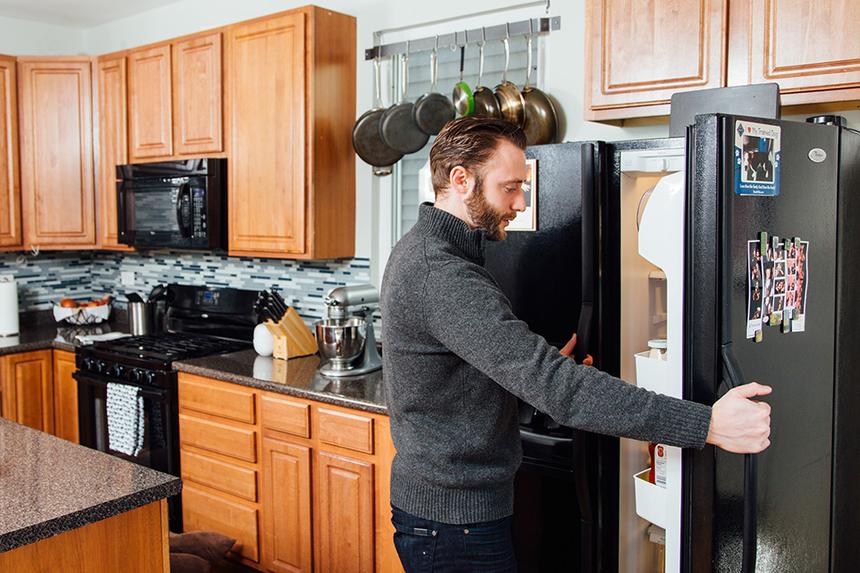 A Man Standing in Front of the Fridge